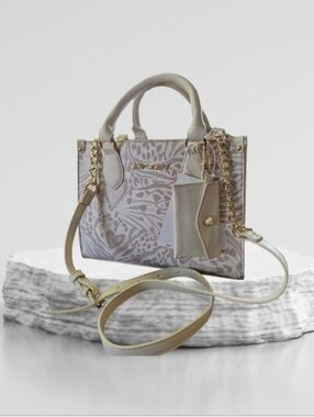 Betsey Johnson satchel bag featuring a white and blush animal print & gold-tone